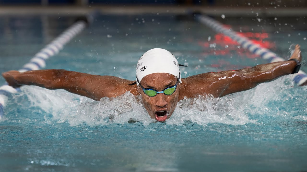 Swimmer racing butterfly stroke in a pool