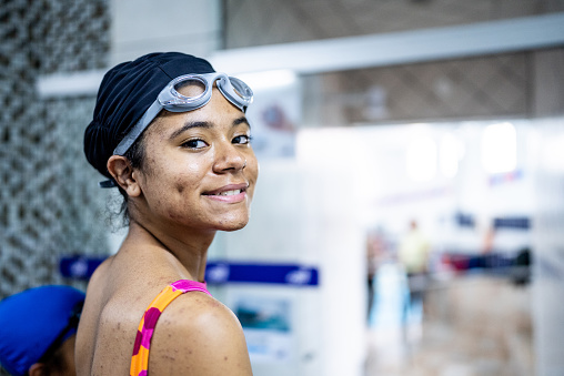 Smiling swimmer in a swim cap and goggles