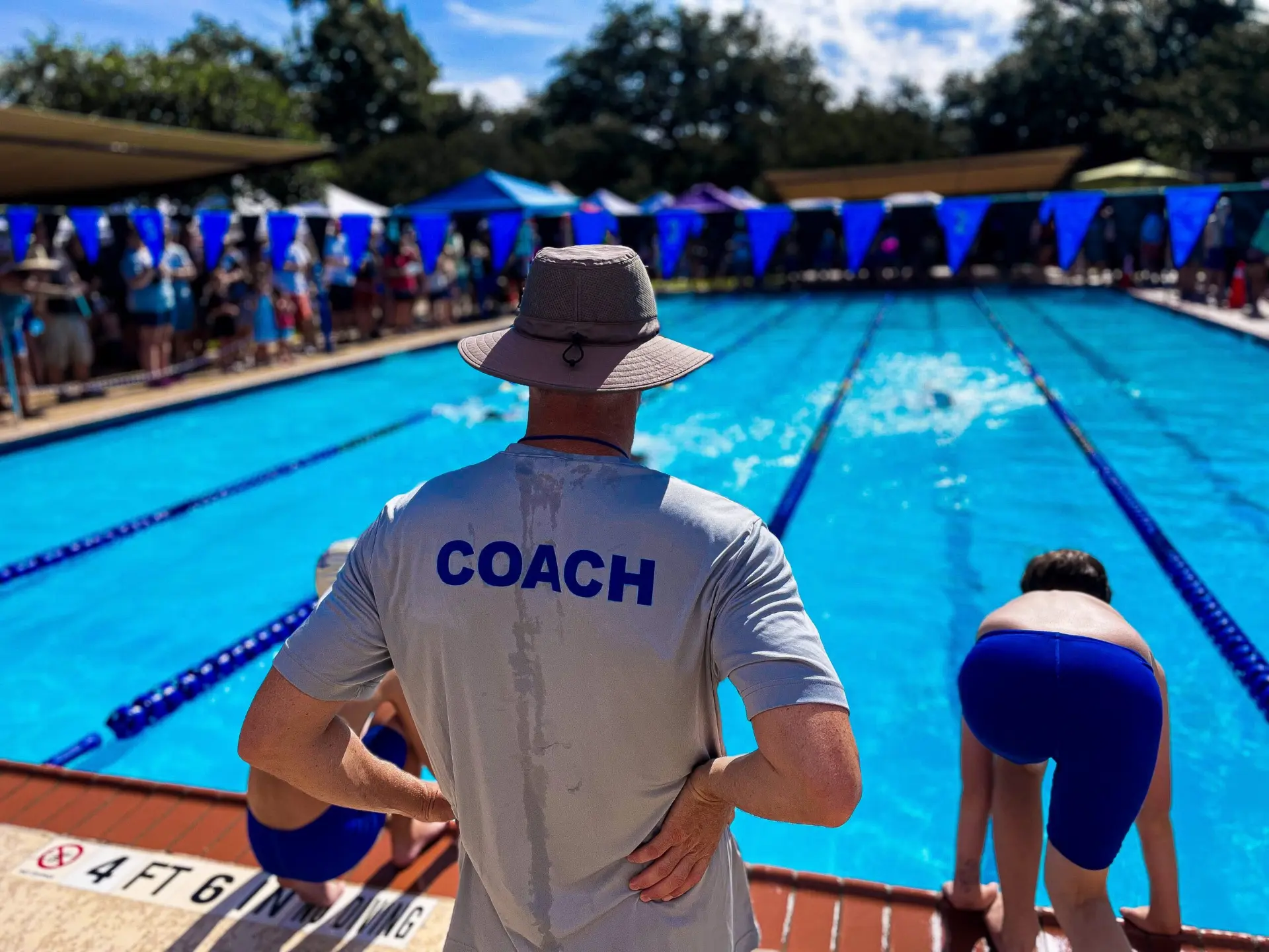 Coach watching swimmers at the pool